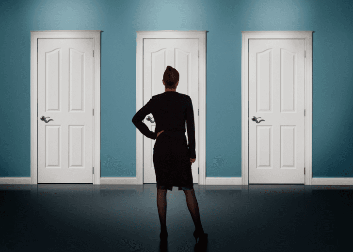 A woman facing three doors.