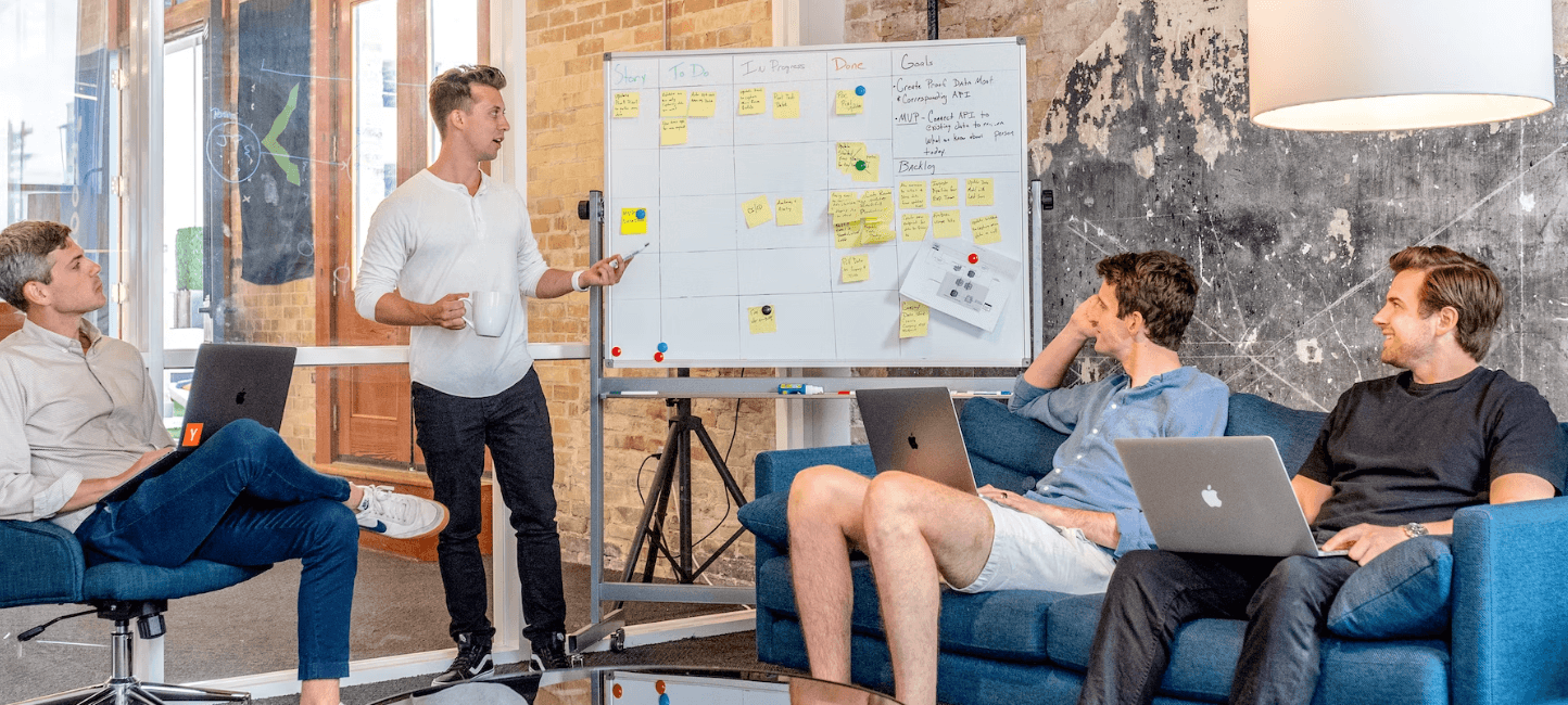 A person demonstrating leadership by explaining the content on the board.
