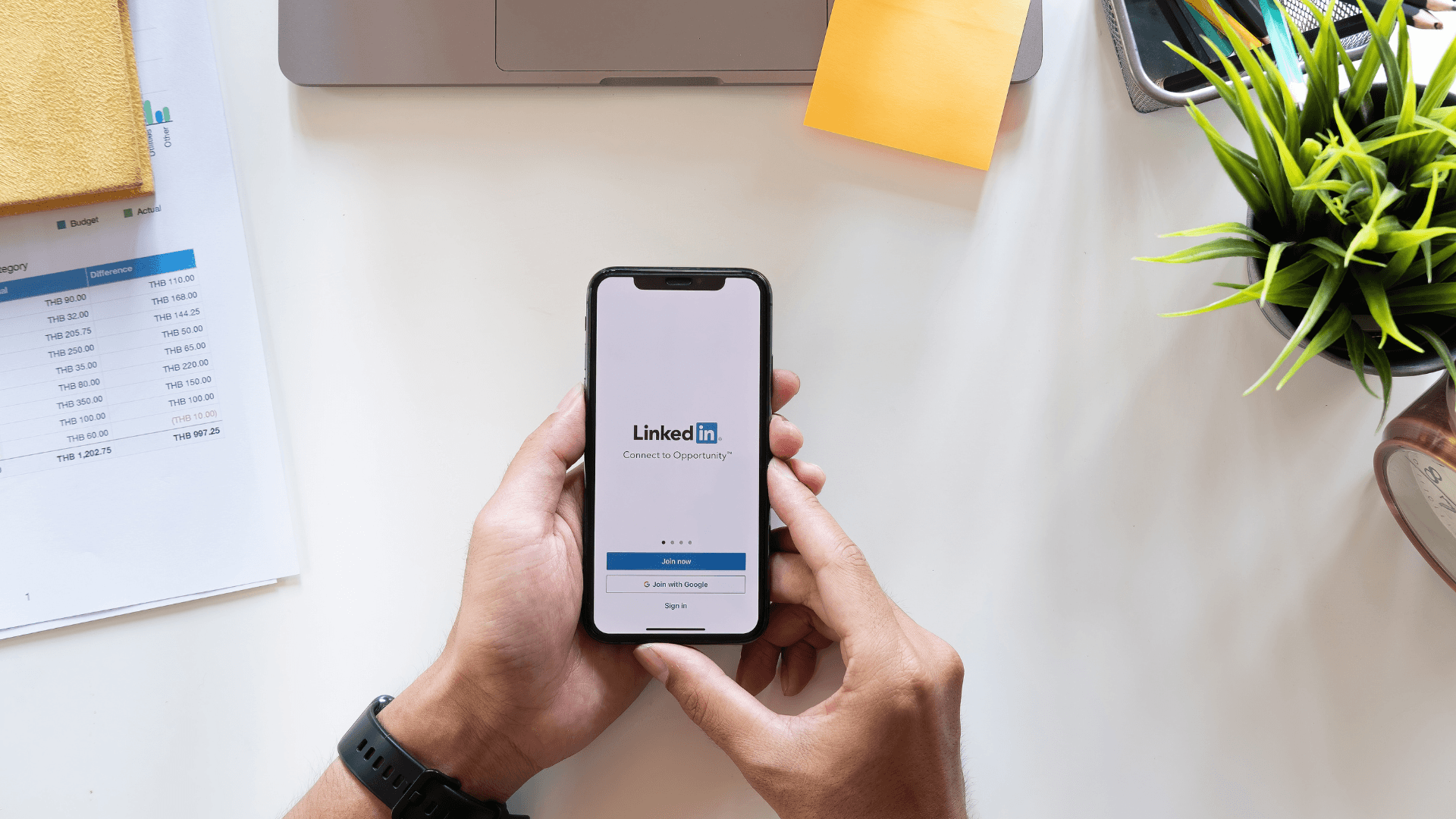 A phone showing LinkedIn wallpaper.