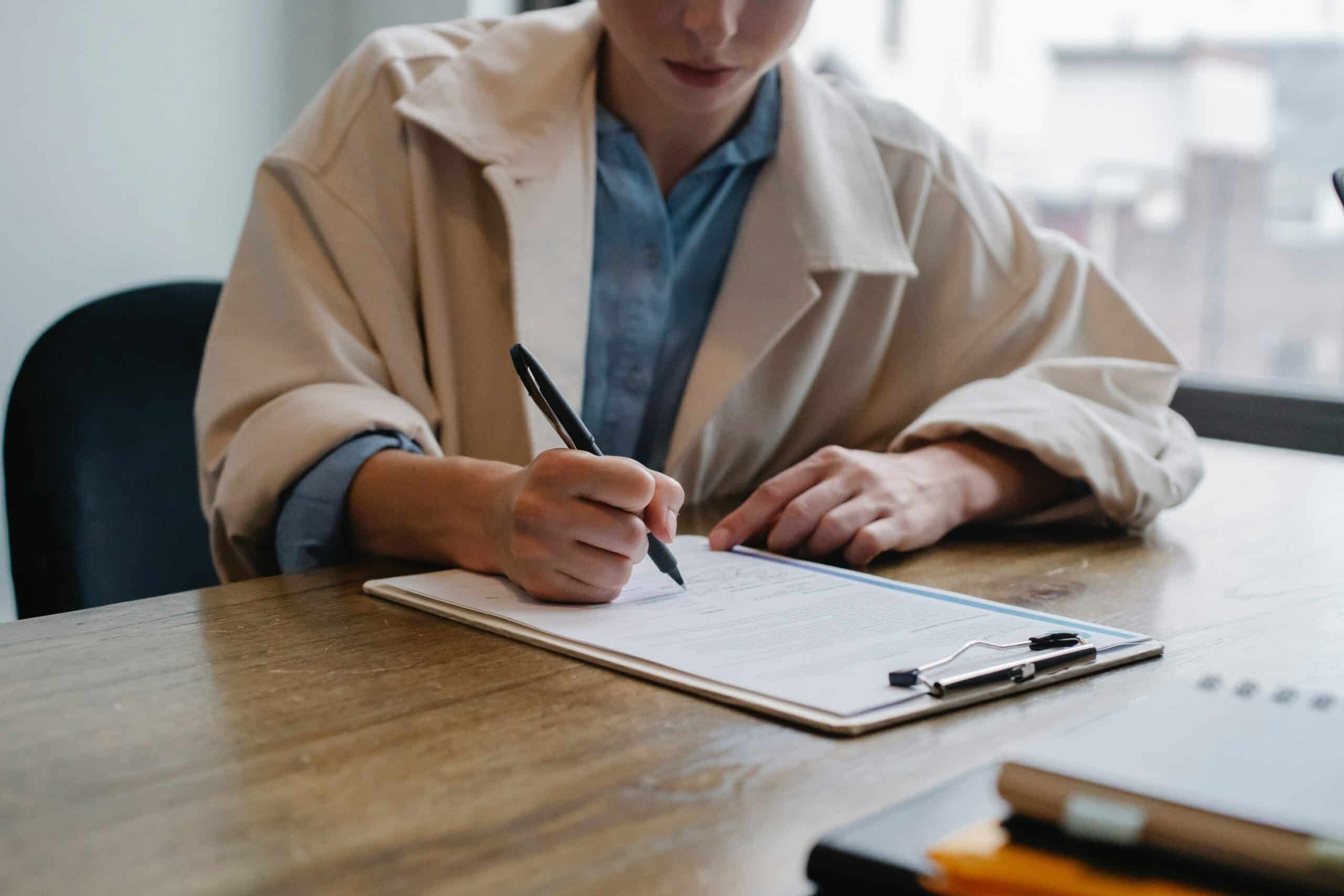 a woman at a job interview writing